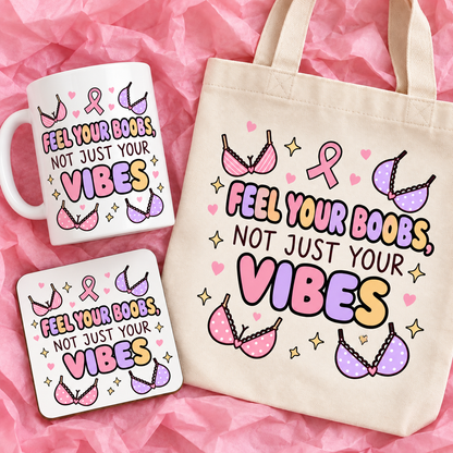 Matching breast cancer awareness gift set with 11oz mug, square ceramic coaster and tote bag on pink tissue paper.