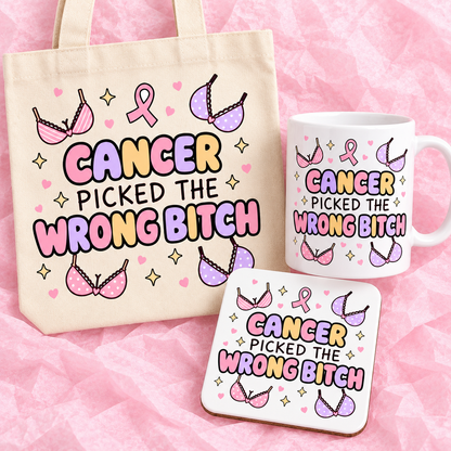 Matching breast cancer awareness gift set with 11oz mug, square ceramic coaster and tote bag on pink tissue paper.