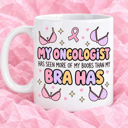 Breast cancer awareness 11oz ceramic mug with funny survivor design on pink tissue paper.