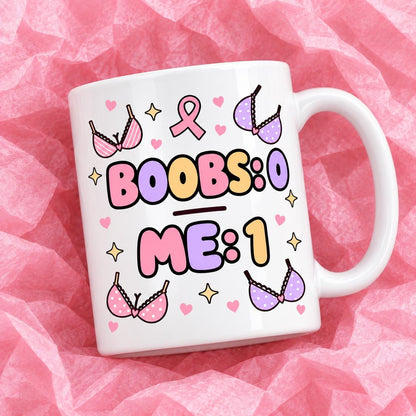 Breast cancer awareness 11oz ceramic mug with funny survivor design on pink tissue paper.