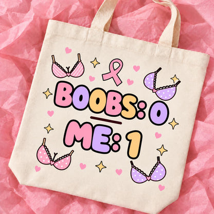 Breast cancer awareness 15x13 inch tote bag with funny survivor design on pink tissue paper.
