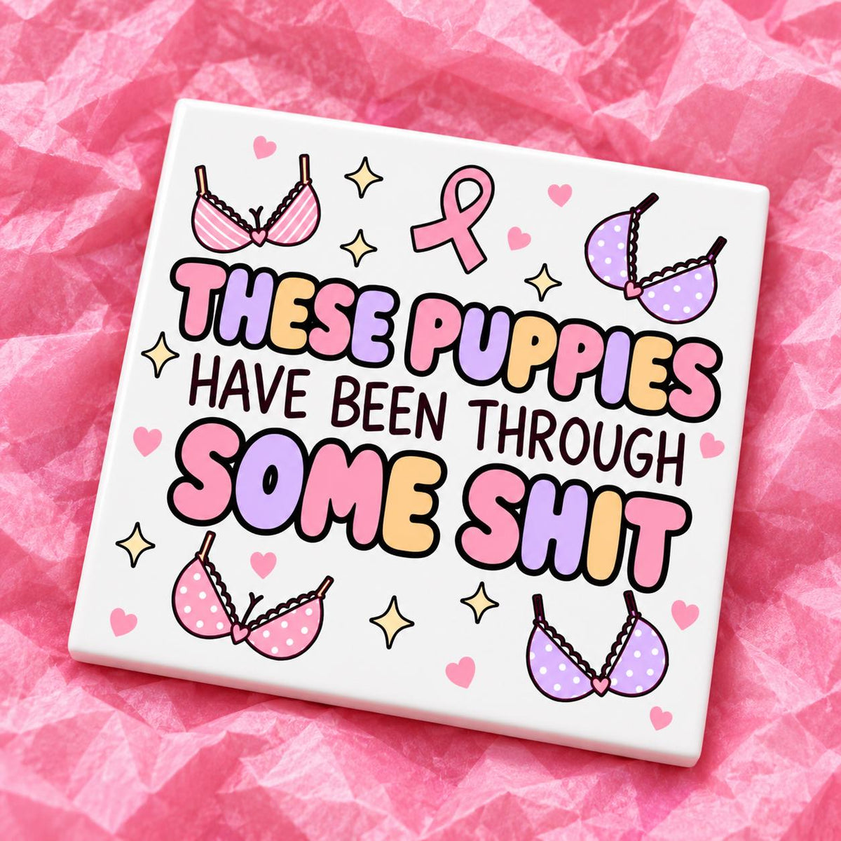 Square 10x10cm ceramic breast cancer awareness coaster with survivor design on pink tissue paper.