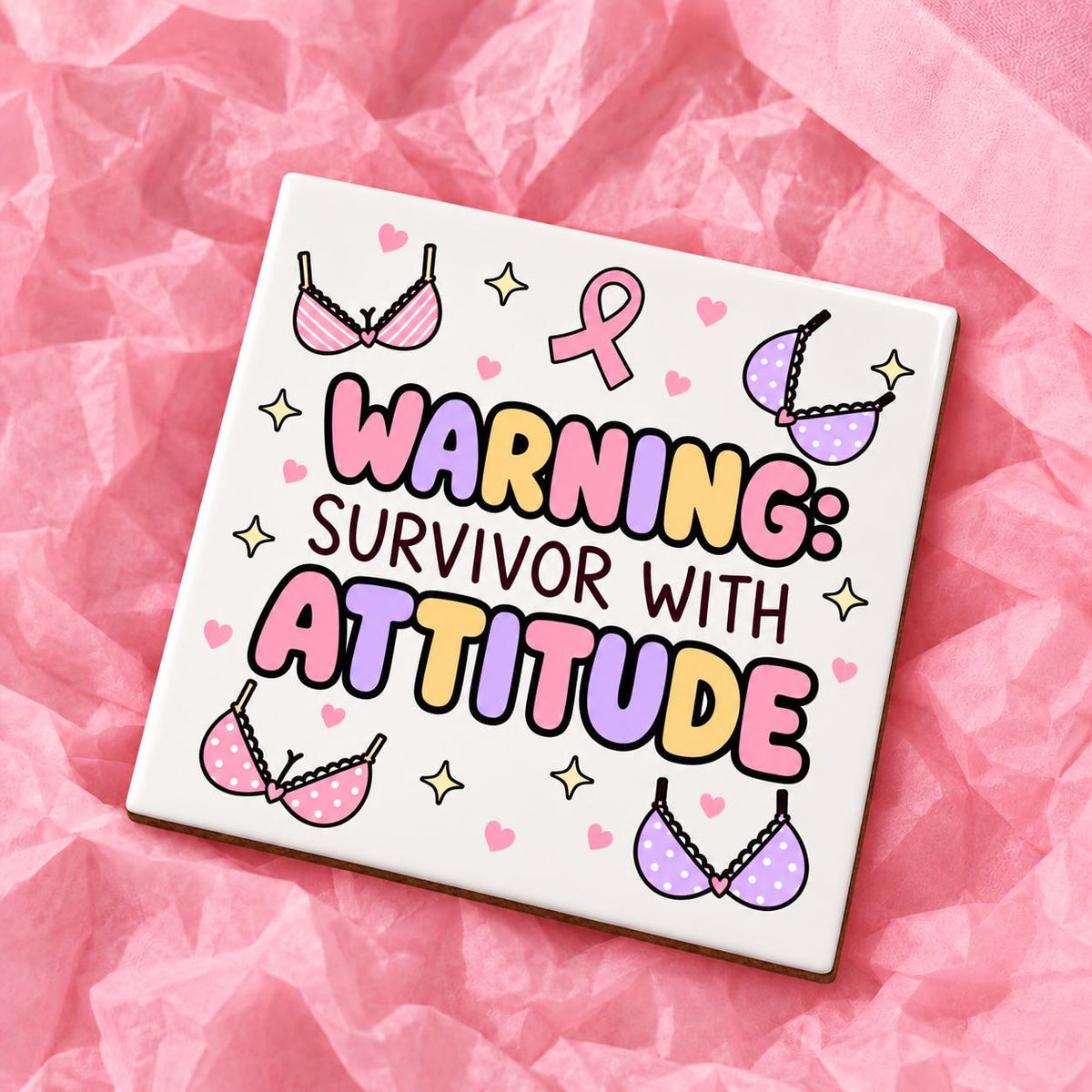 Square 10x10cm ceramic breast cancer awareness coaster with survivor design on pink tissue paper.