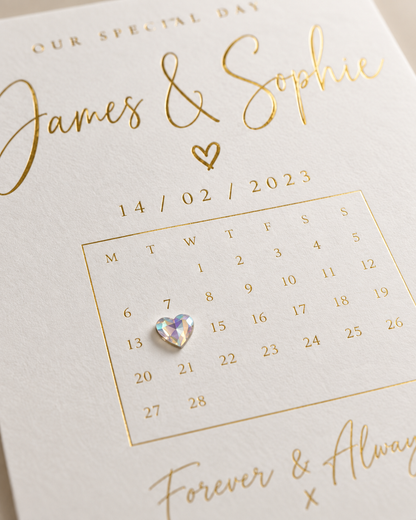 Close-up of foiled special date print showing raised iridescent heart gemstone